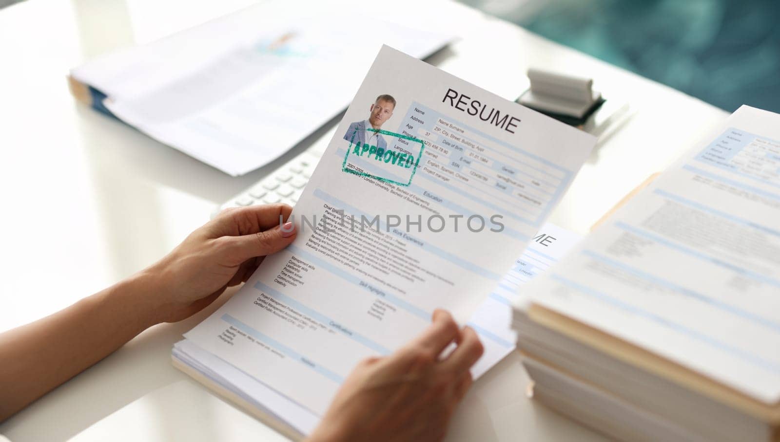 Hands holding resume of man for employment with stamp approved closeup. Work searches concept