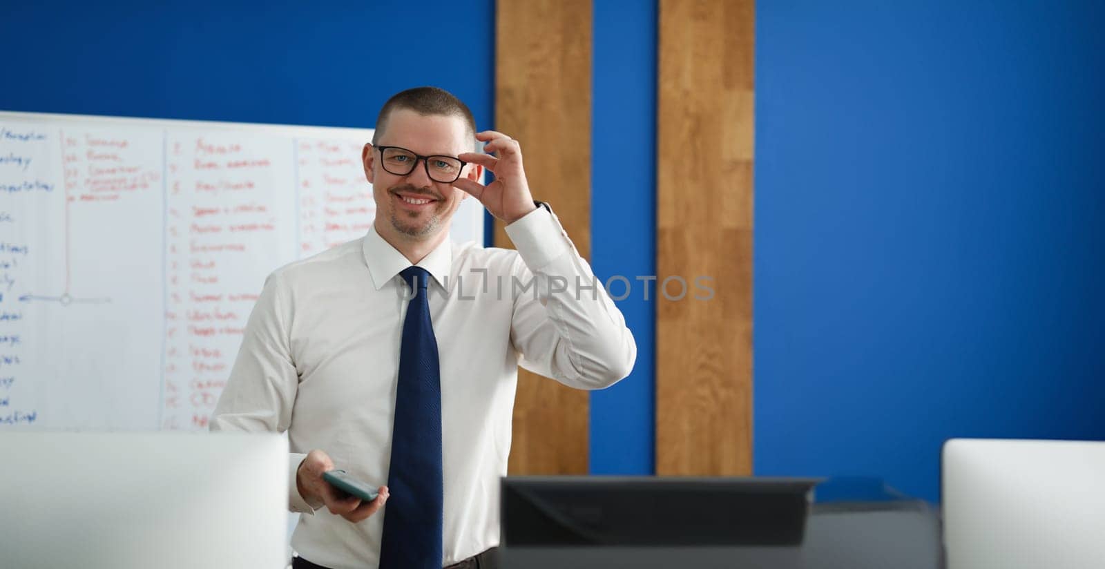 Male business coach smiling, close-up, blurry. Staff training, motivation and inspiration in the workplace
