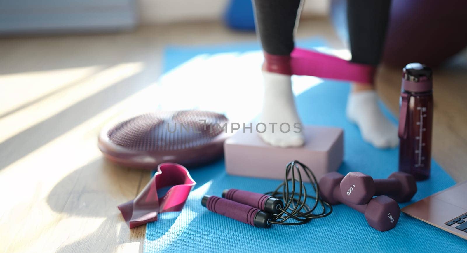 Ankle elastic for fitness, close-up, blurry. A set of equipment for sports training. Pilates, physiotherapy, yoga