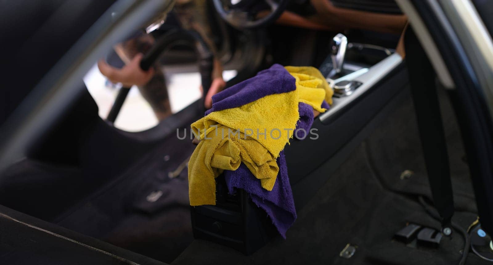 Microfiber towels in the car, interior cleaning, close-up, blurry. Professional car dry cleaning service