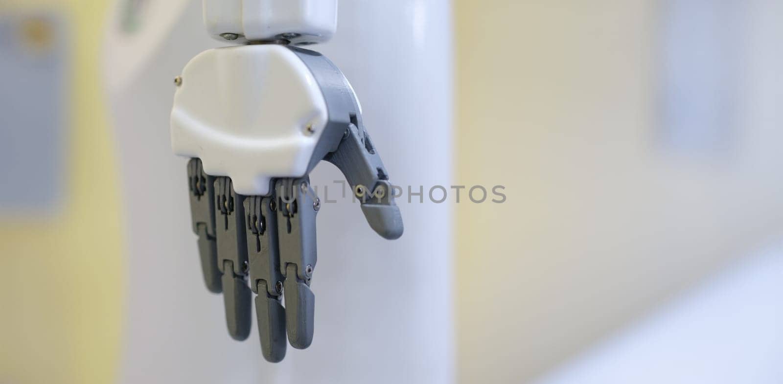 Robot hand on a gray background, close-up. Industrial robotics. Mechanical assistant. Bionic manipulator