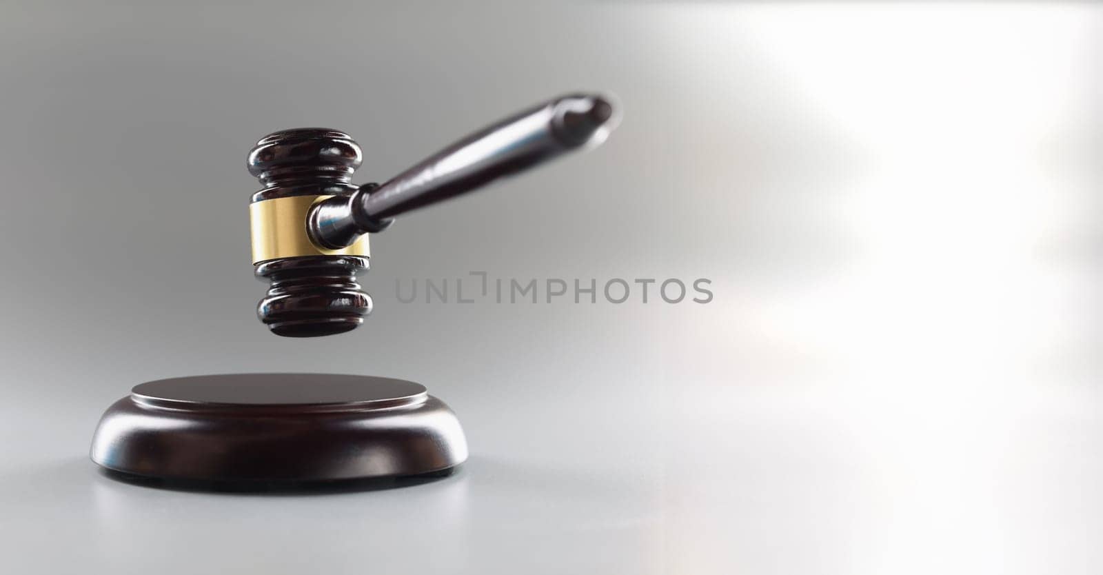 Brown judge's gavel on a gray background, close-up. The concept of an unfair trial, corruption in the judicial system
