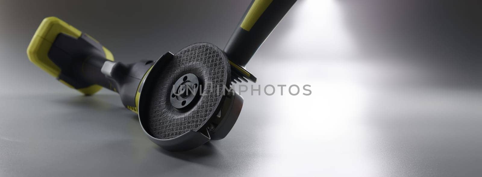 Cordless hand sander on a gray background, close-up. Electric power tools. DIY repair, construction equipment