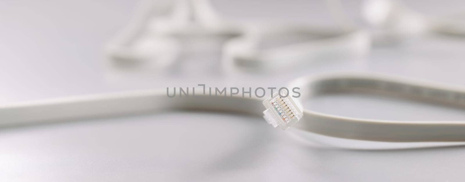 Ethernet LAN carrier and cable on a gray background, close-up. Cables and connectors used for data transmission