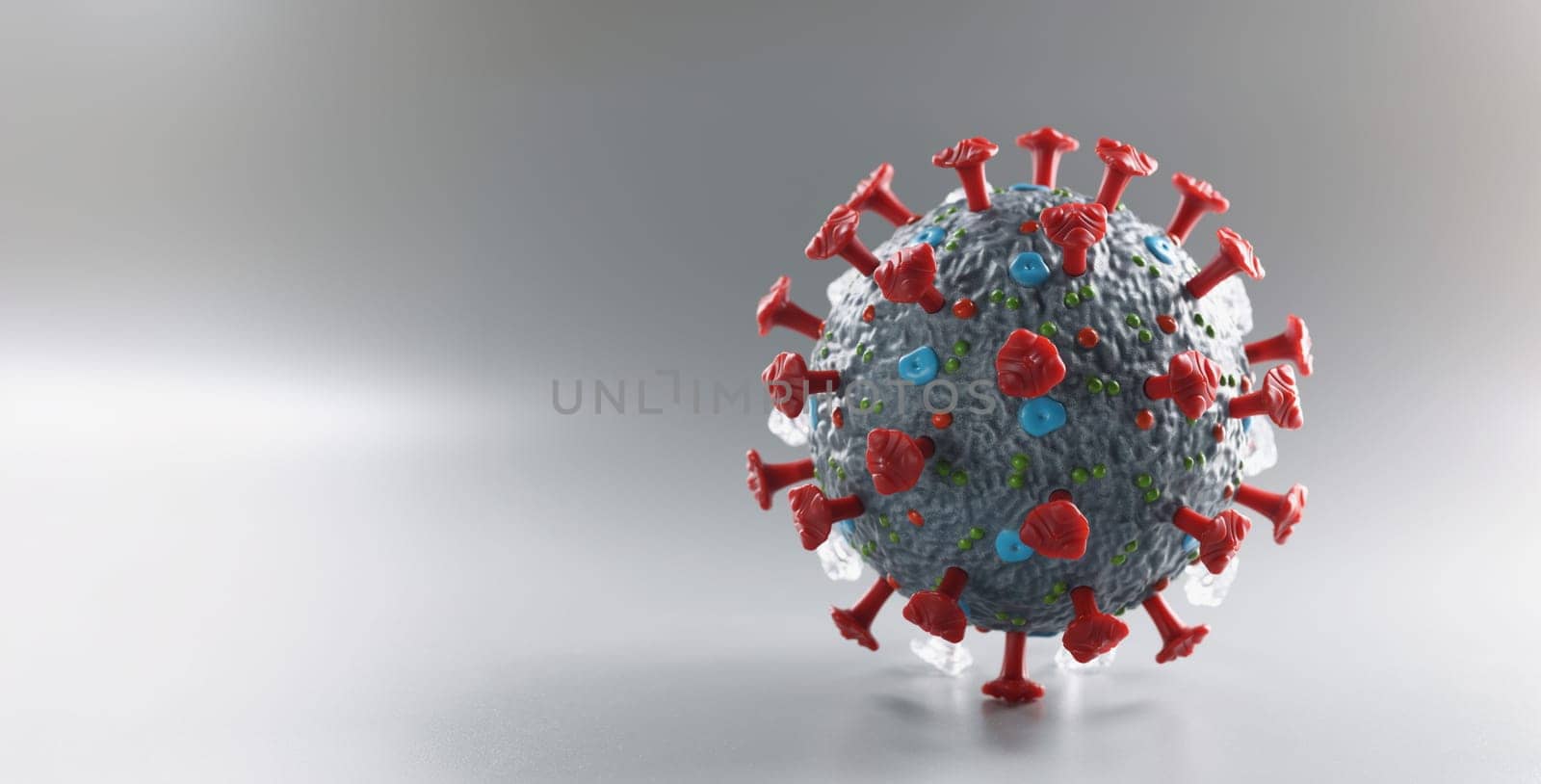 Plastic 3d model of coronavirus on a gray background, close-up. Search for a vaccine against omicron. Covid treatment. PCR test