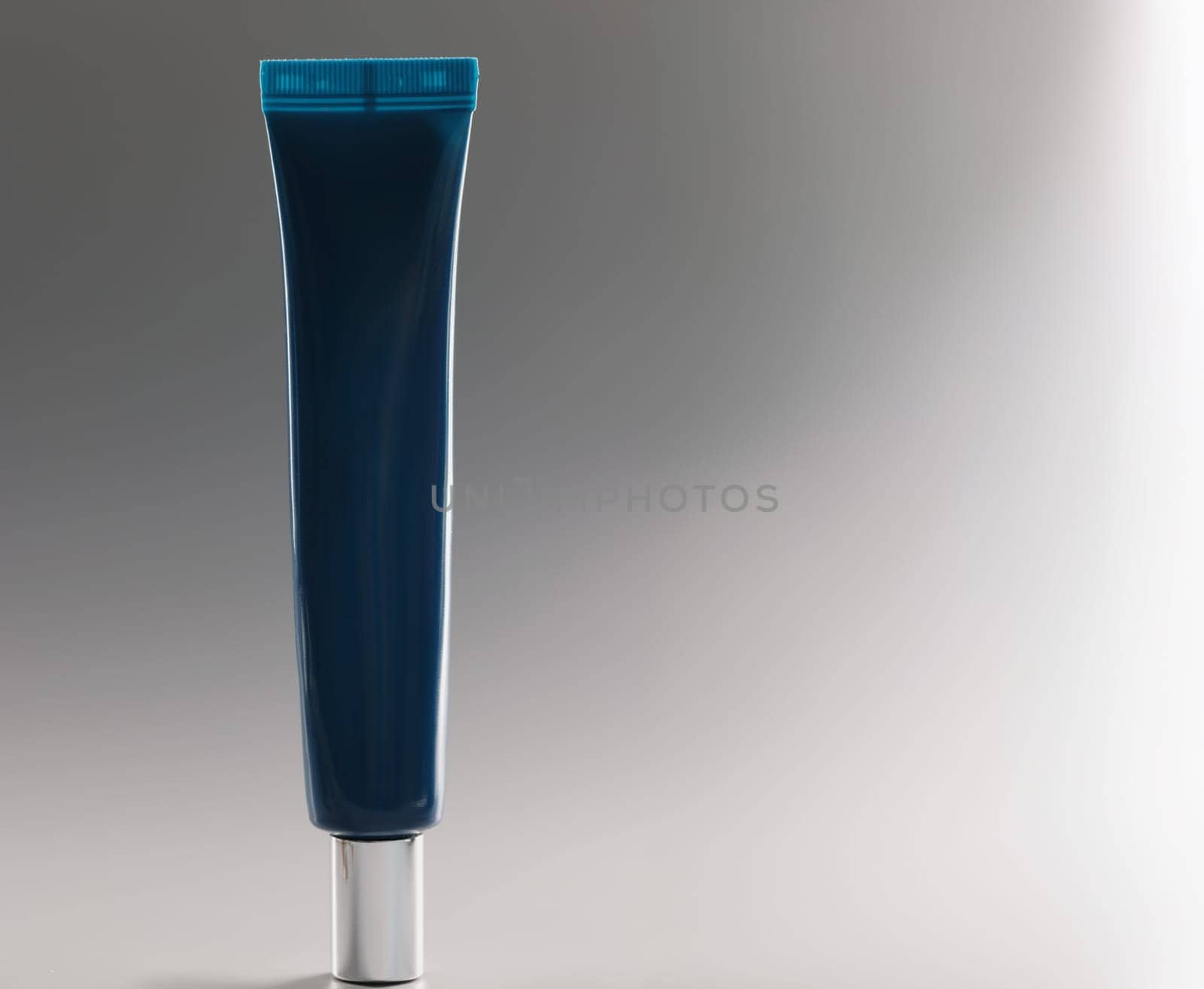 Blue tube with cream on a gray background, close-up. Facial cosmetics, non-comedogenic, skincare and makeup products