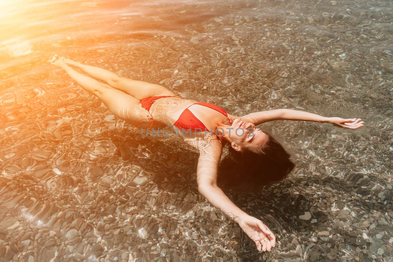 Weight loss and body image concept. Woman with perfect fit body walking confident on beach. Unrecognizable sexy young woman.