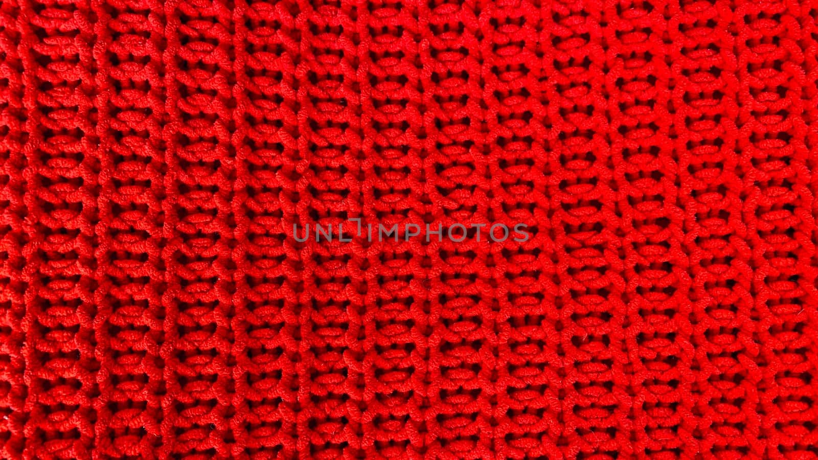Red knitted wool fabric texture as background
