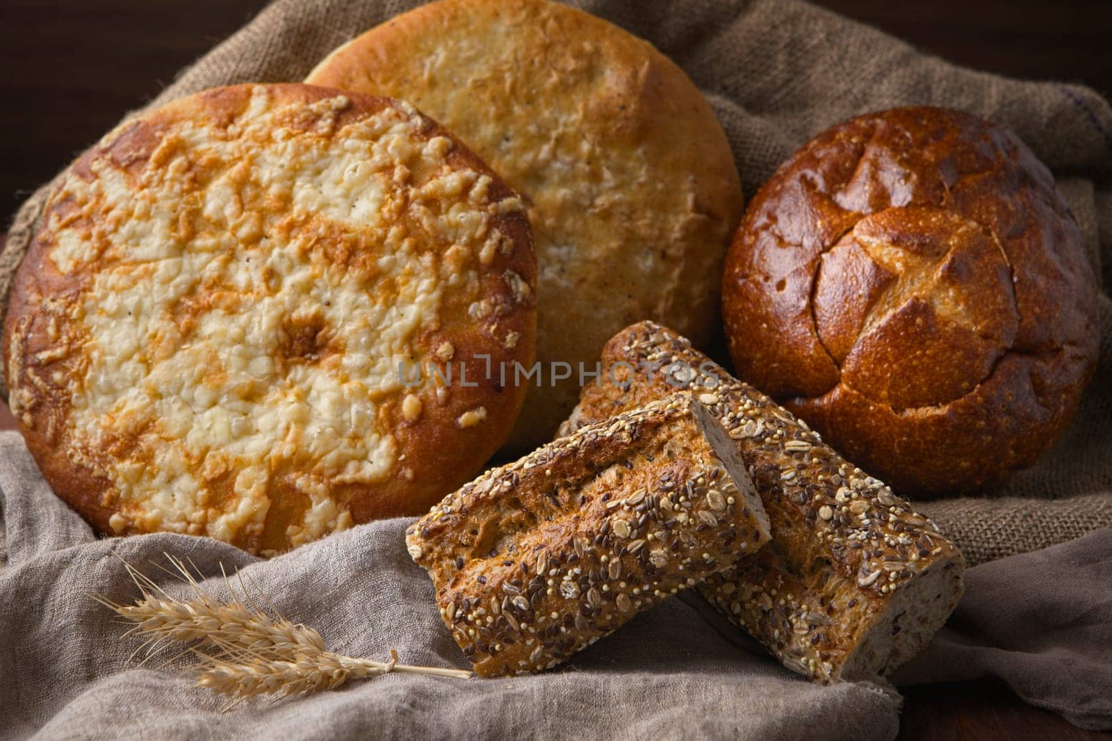 A close up still life photo of various loafs of natural whole bread.
