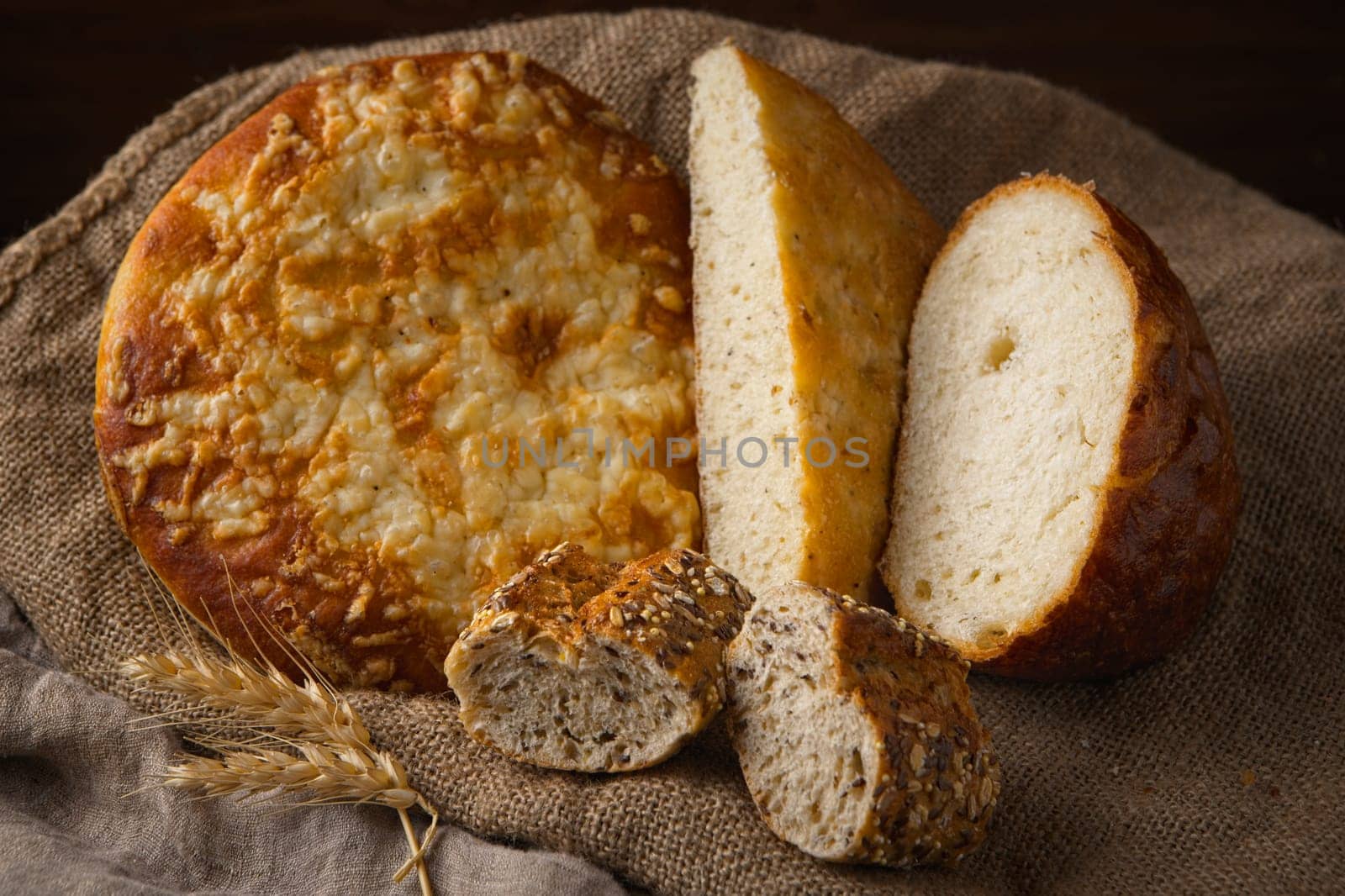A close up still life photo of various loafs of natural whole bread.