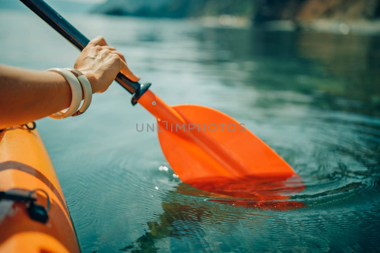 Kayak paddle sea vacation. Person paddles with orange paddle oar on ...