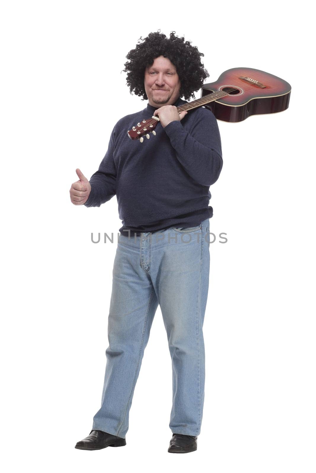 in full growth. curly-haired mature man with a guitar. isolated on a white background.