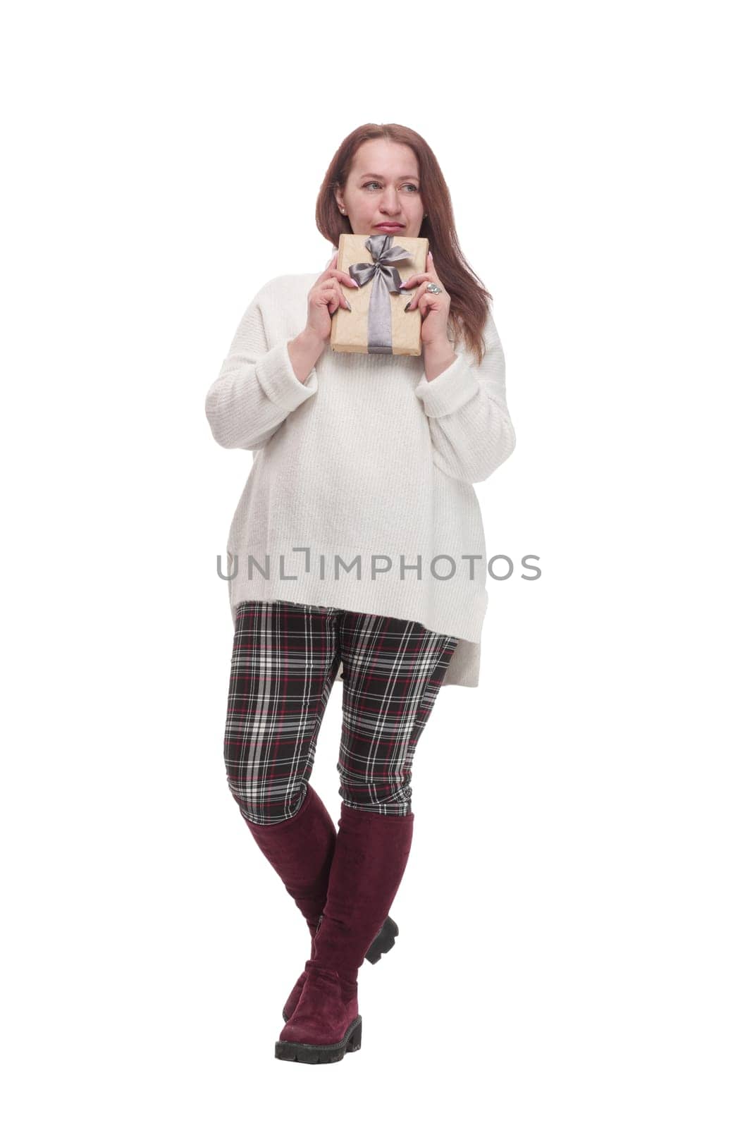 in full growth. attractive casual woman with a gift box .isolated on a white background.