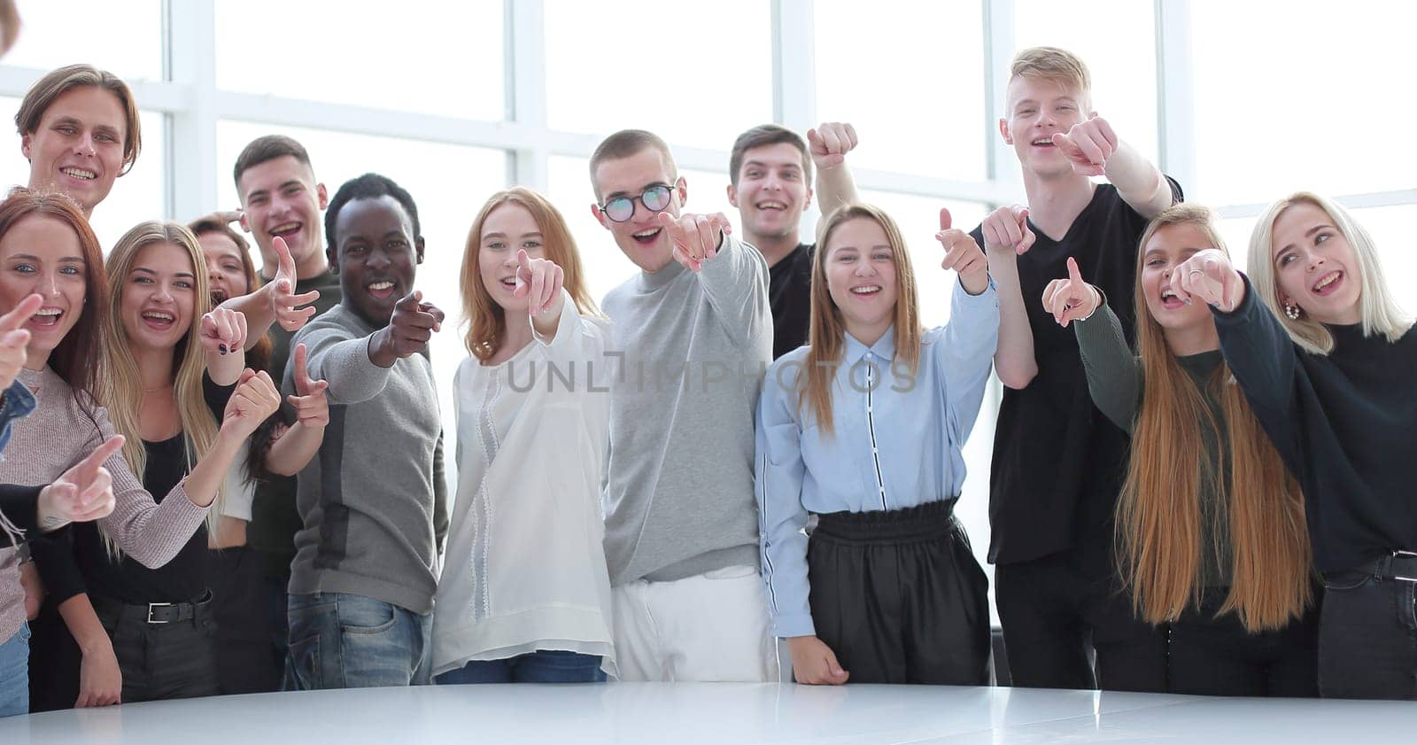 multinational group of young people pointing at you. photo with copy space