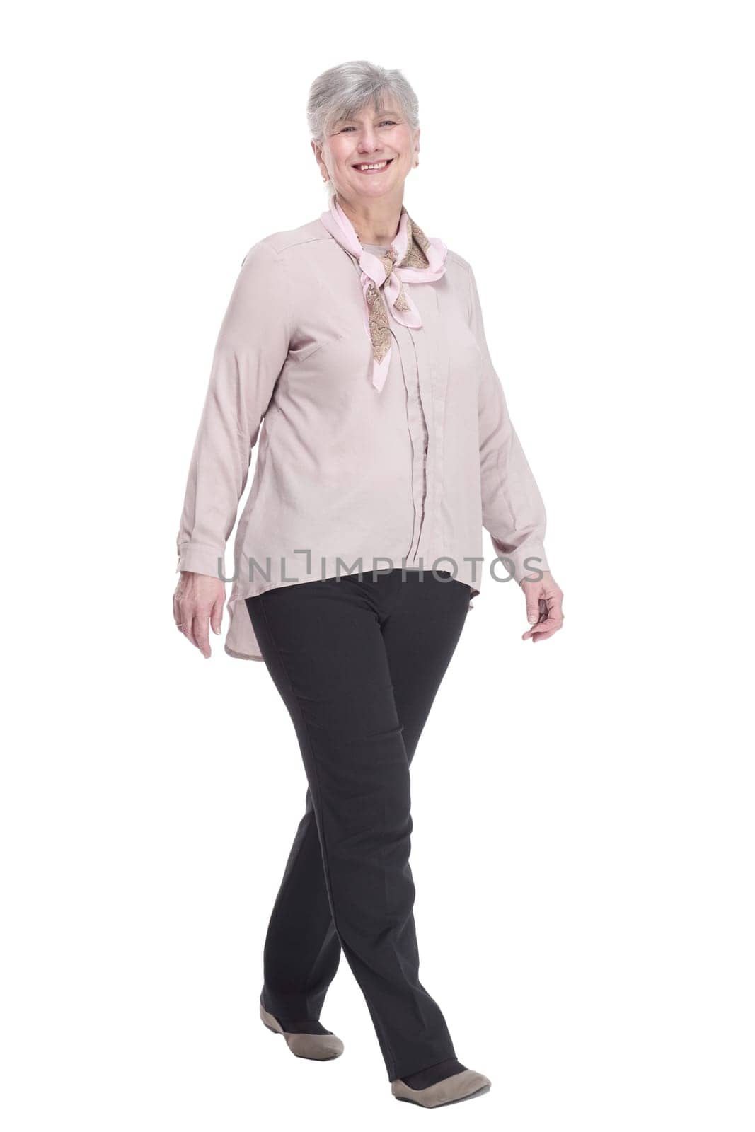 in full growth. confident old lady striding forward. isolated on a white background.
