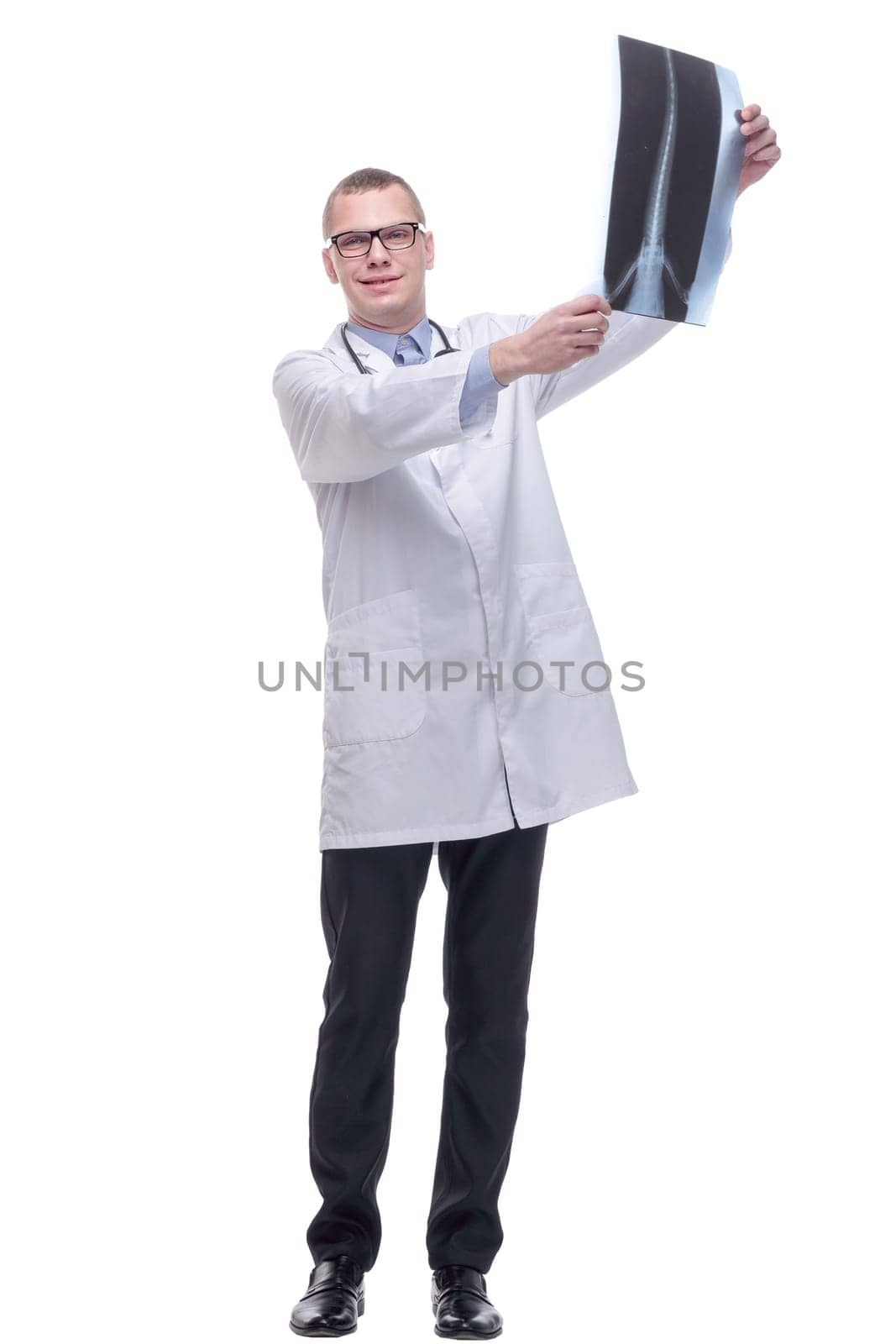 Front view of a doctor with stethoscope studying x-ray image. Isolated on white background