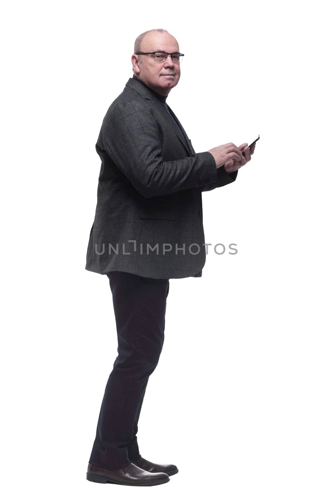 in full growth. business man talking on a smartphone . isolated on a white background