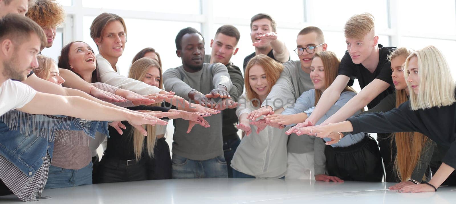 multinational group of young people joining their palms. photo with copy space