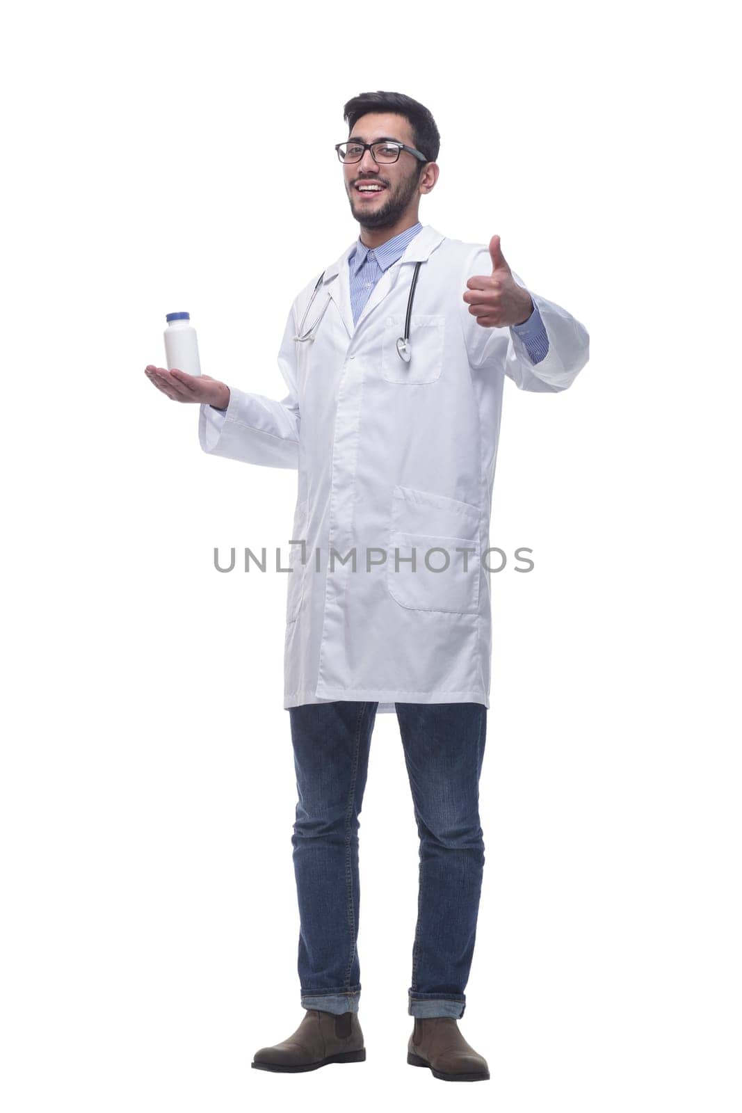 in full growth. smiling doctor pointing at hand sanitizer . isolated on a white background.