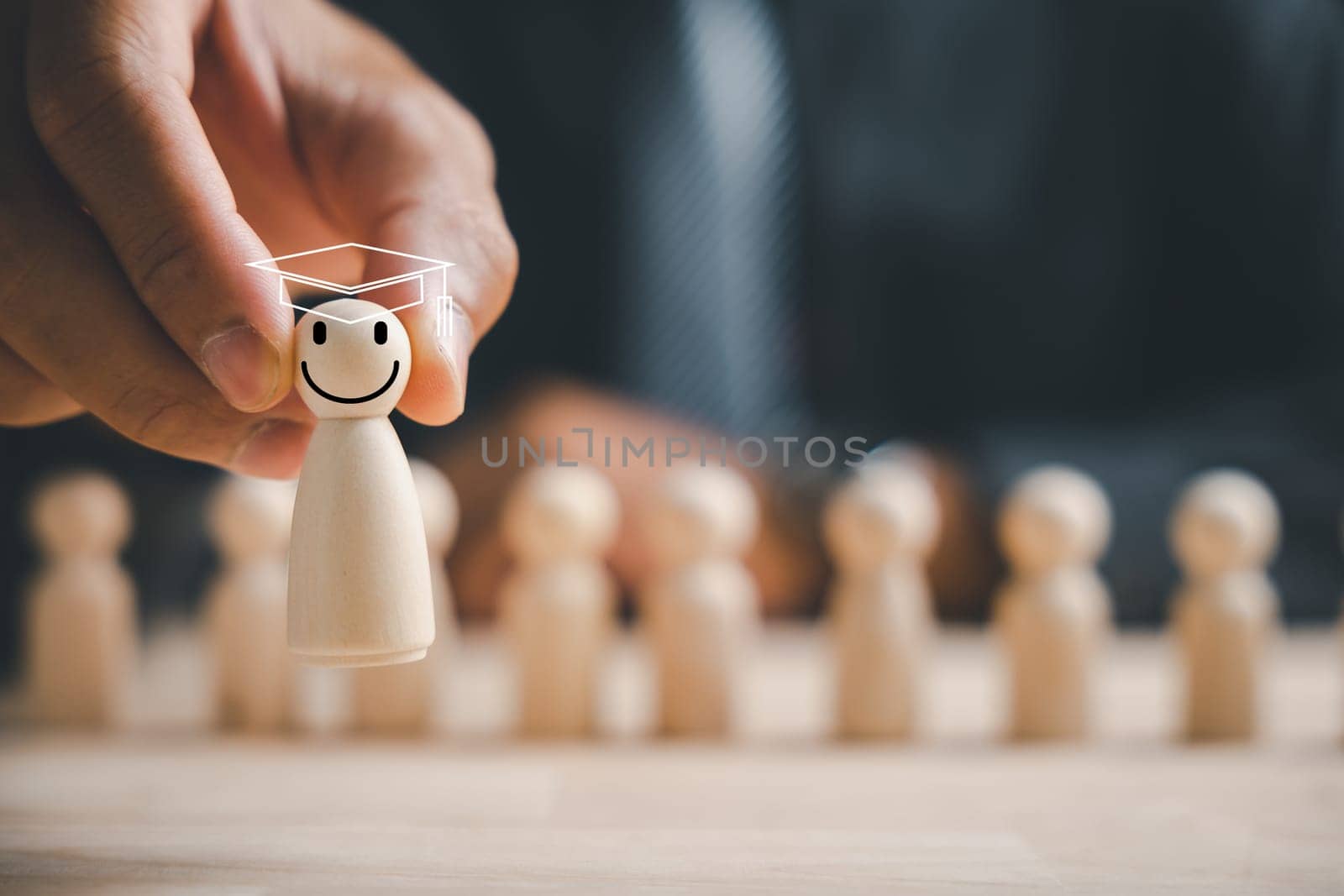 Man hand grasps wooden human figure. HR officer seeks leader and CEO. Leader emerges from the crowd. Personal development, motivation, challenge. HR, HRM, HRD concepts.