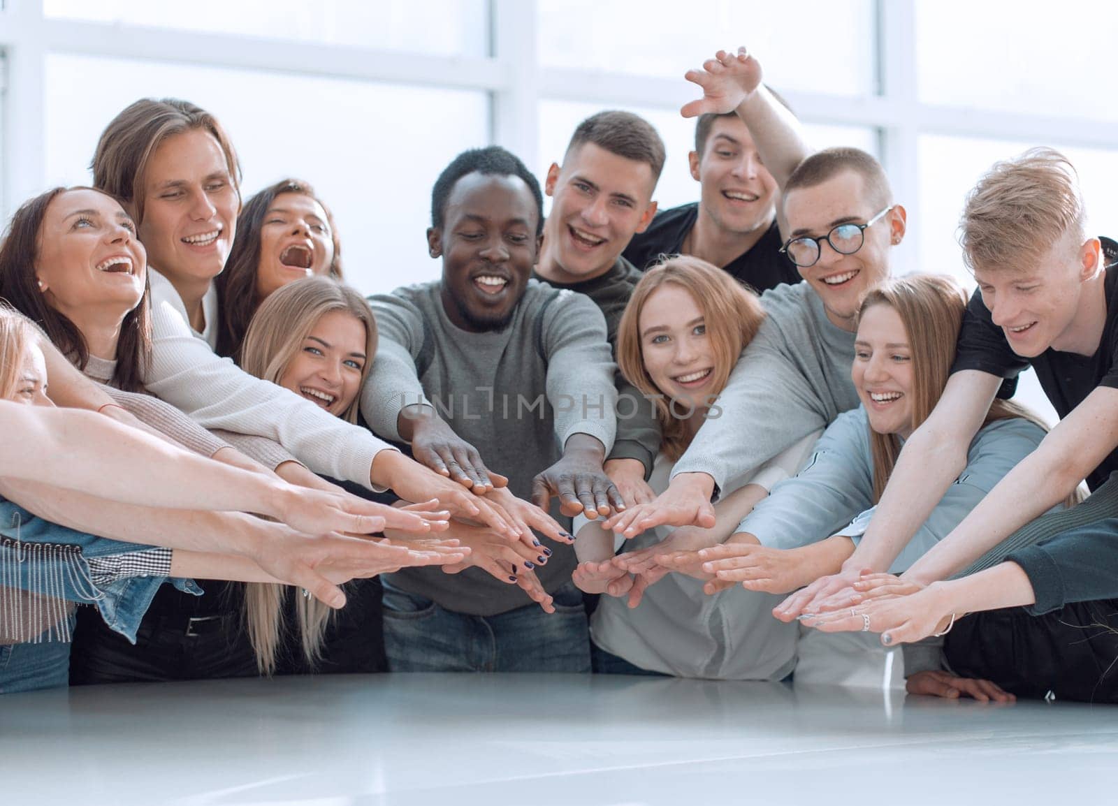 multinational group of young people joining their palms. photo with copy space