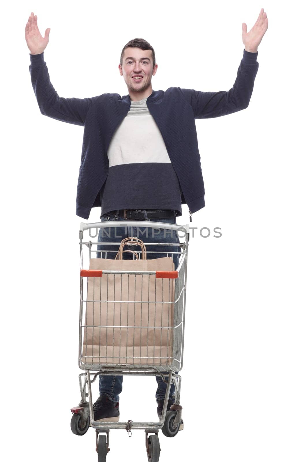 smiling young man with a shopping cart . isolated on a white background.