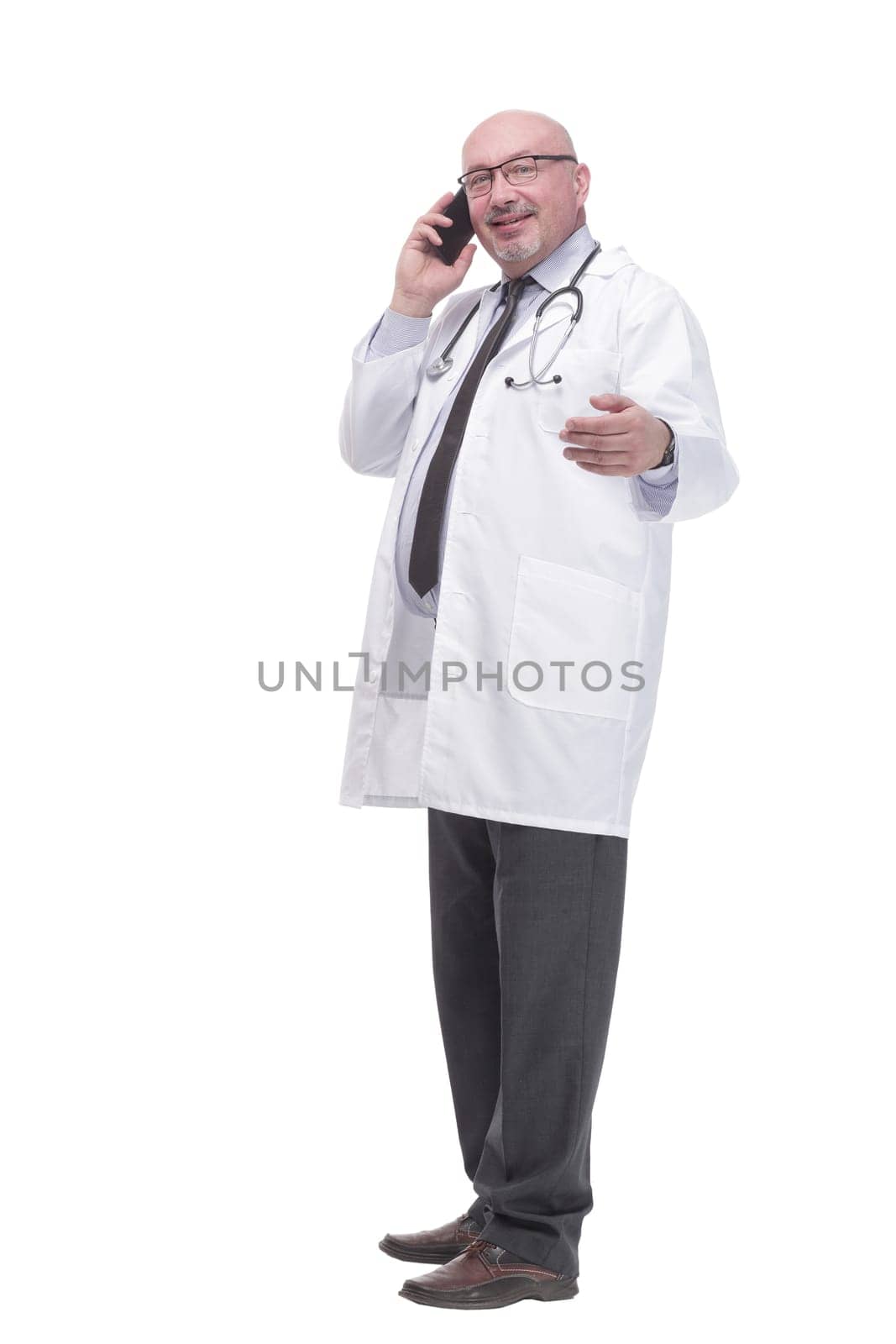 mature doctor with smartphone. isolated on a white background. by asdf