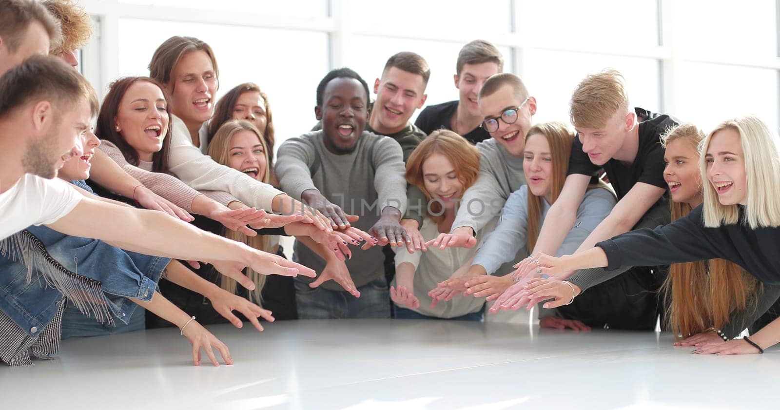 multinational group of young people joining their palms. photo with copy space