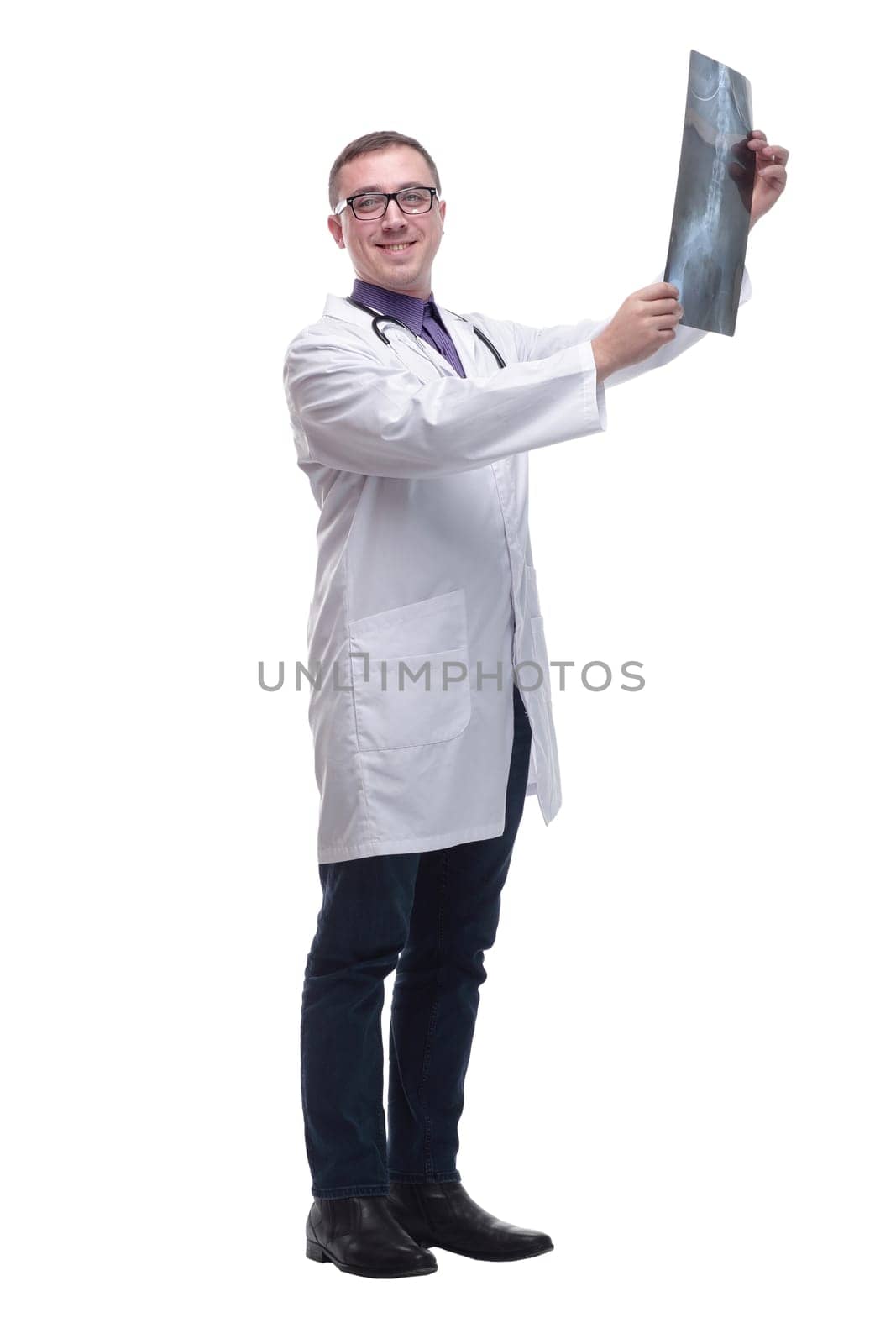 Attractive doctor examining an x-ray and looking at the camera seriously