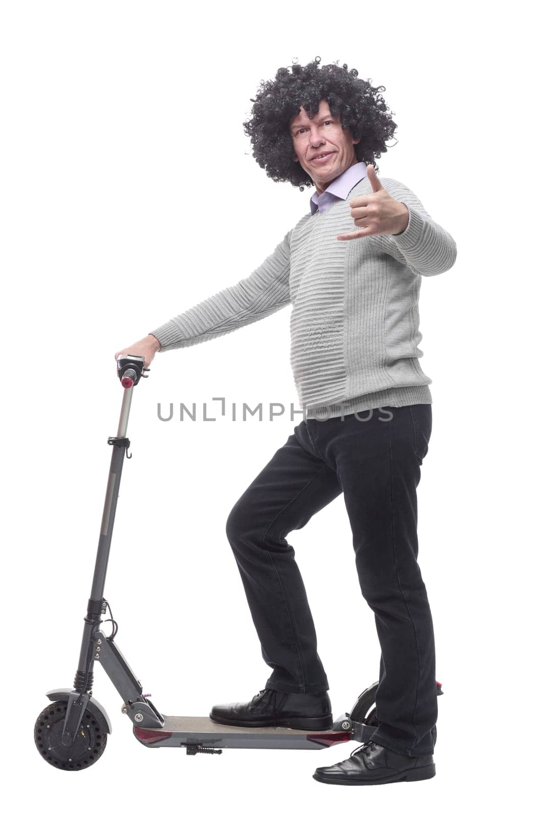 in full growth. cheerful man with an electric scooter. isolated on a white background.