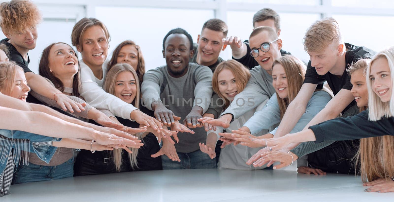 multinational group of young people joining their palms. photo with copy space