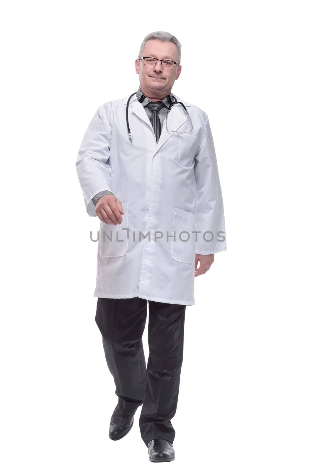 Portrait of mature caucasian friendly walking doctor isolated on white background by asdf