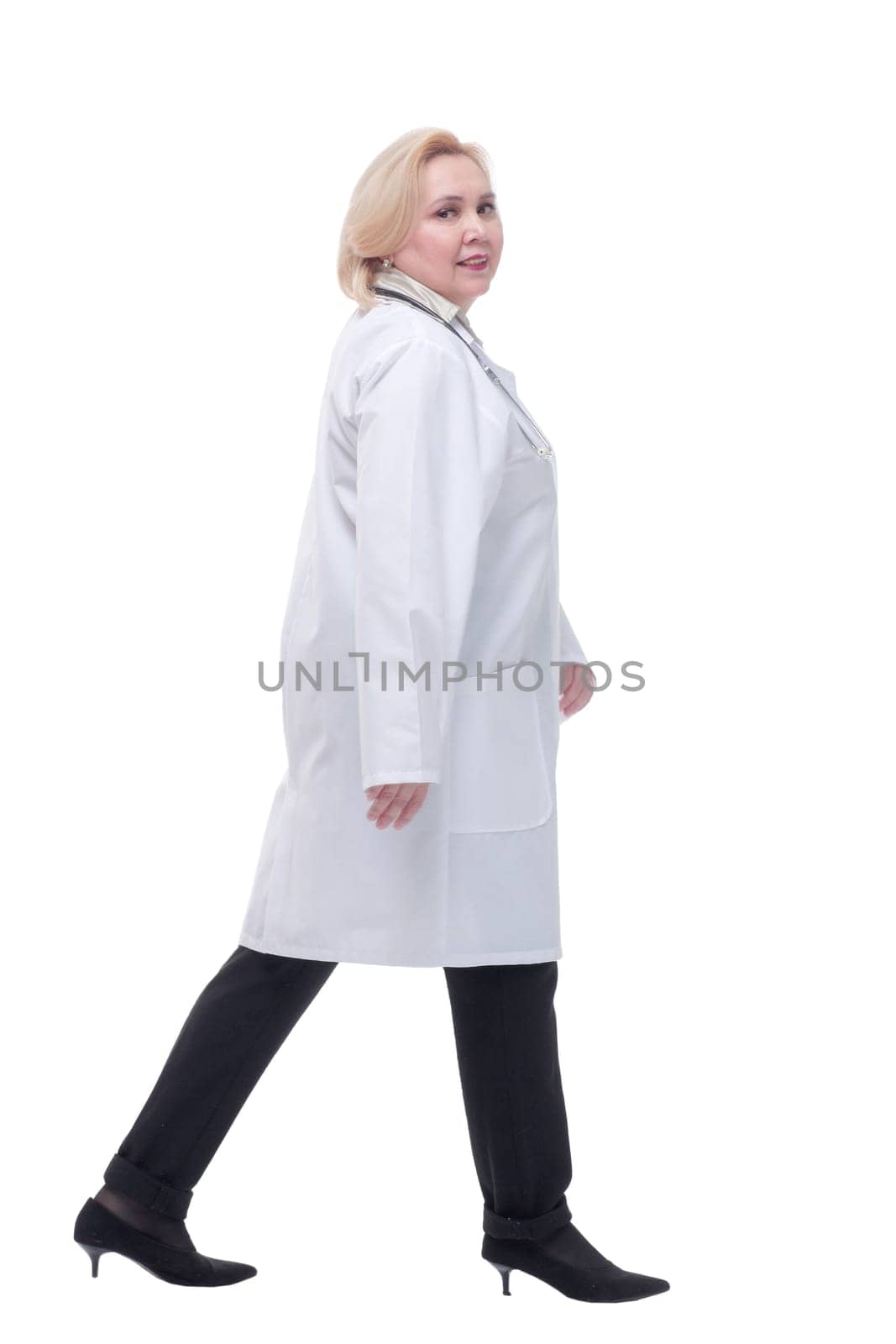 Female doctor walking towards the camera smiling by asdf