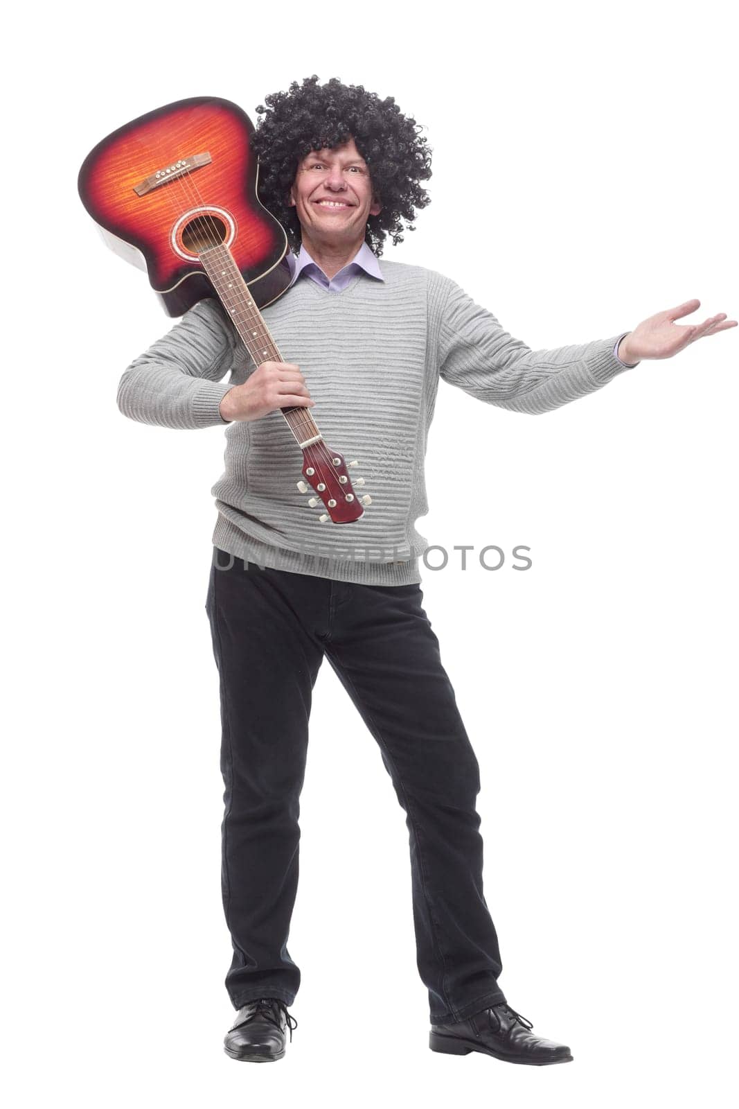 in full growth. cheerful man with a guitar. isolated on a white background.