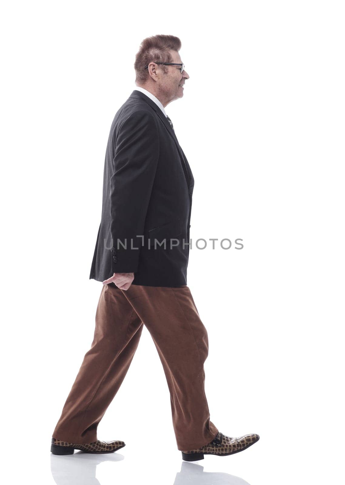 in full growth. smiling business man walking towards you . isolated on a white background
