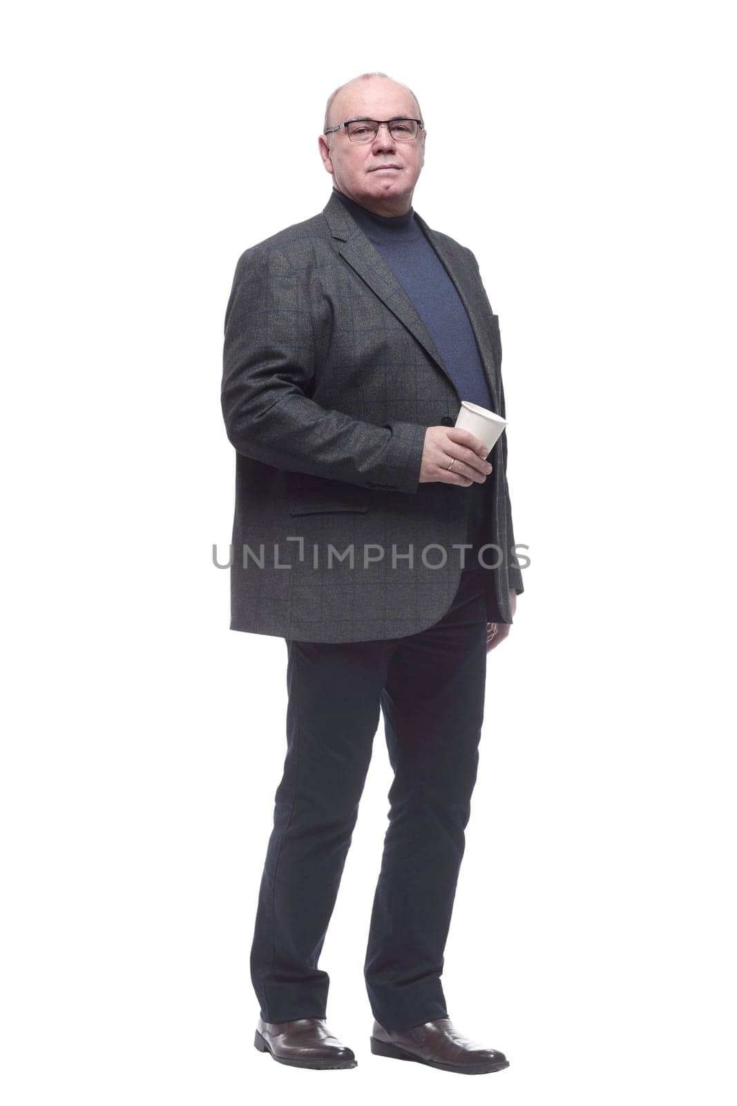 in full growth. confident business man with coffee to take away. isolated on a white background