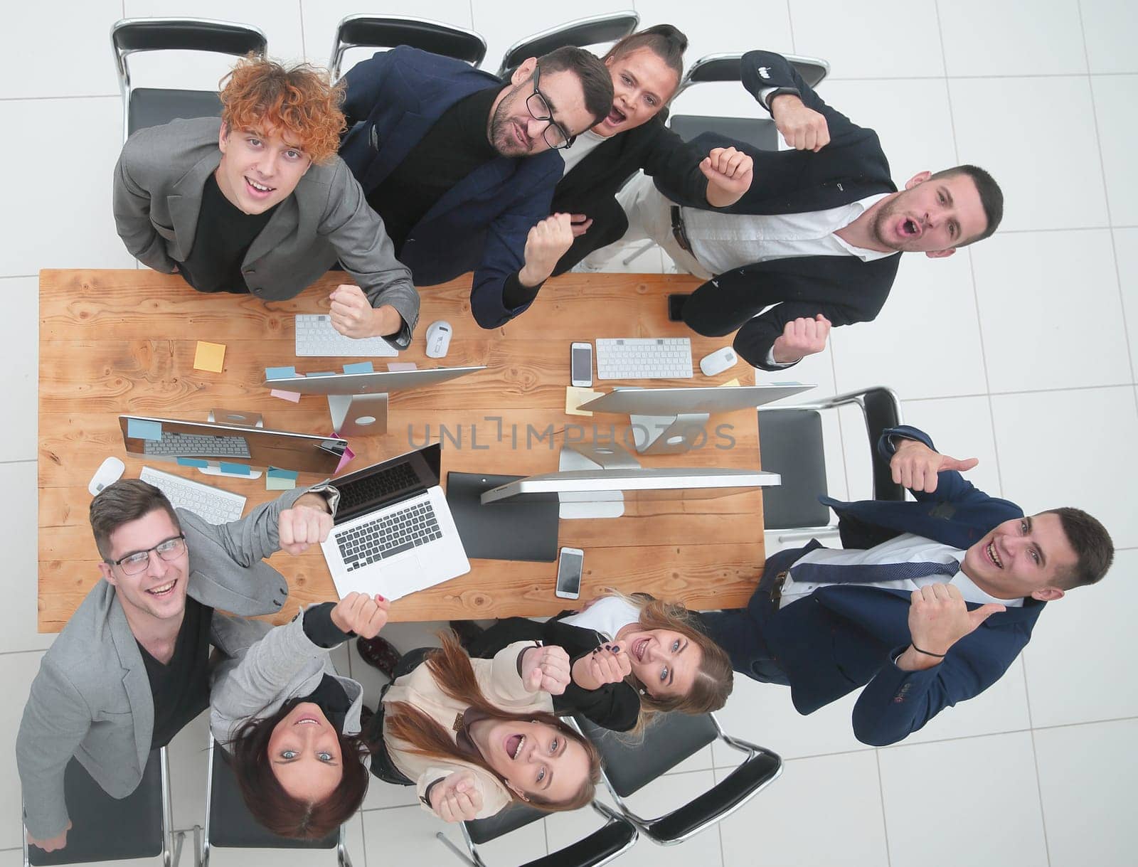 top view. business team celebrating near the desktop by asdf