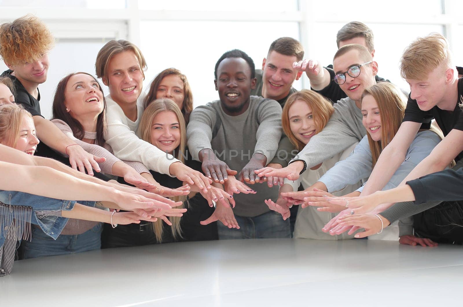 multinational group of young people joining their palms. photo with copy space