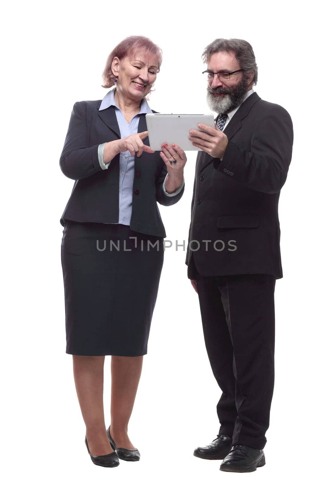 in full growth. businessman and businesswoman using a digital tablet. isolated on a white