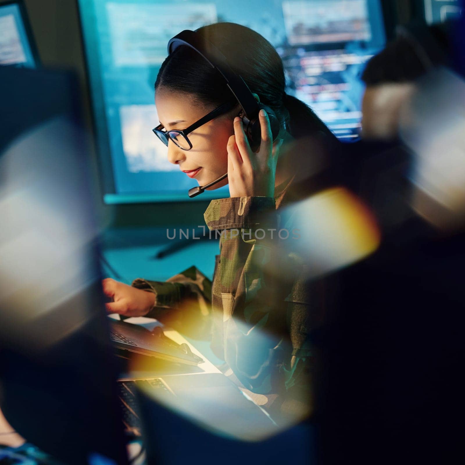 Military command center, headset and woman with communication, computer and technology. Security, global surveillance and soldier with teamwork in army office at government cyber data control room