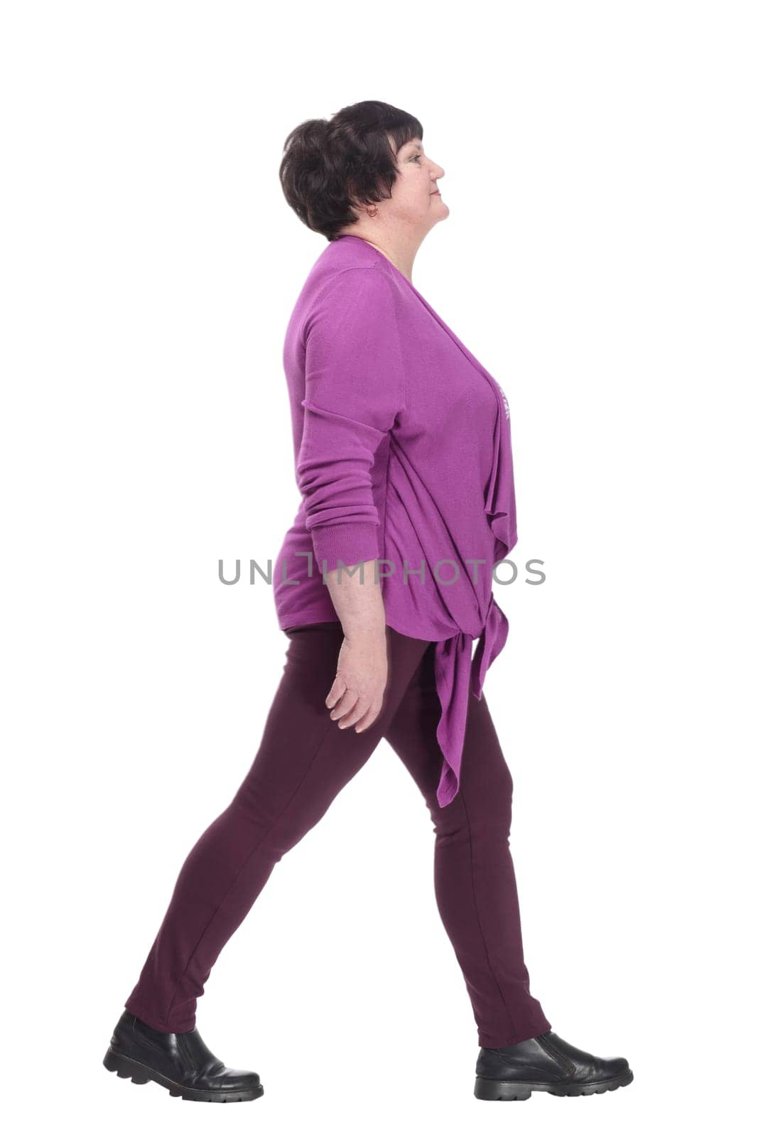 casual elderly woman in a purple blouse striding forward. by asdf