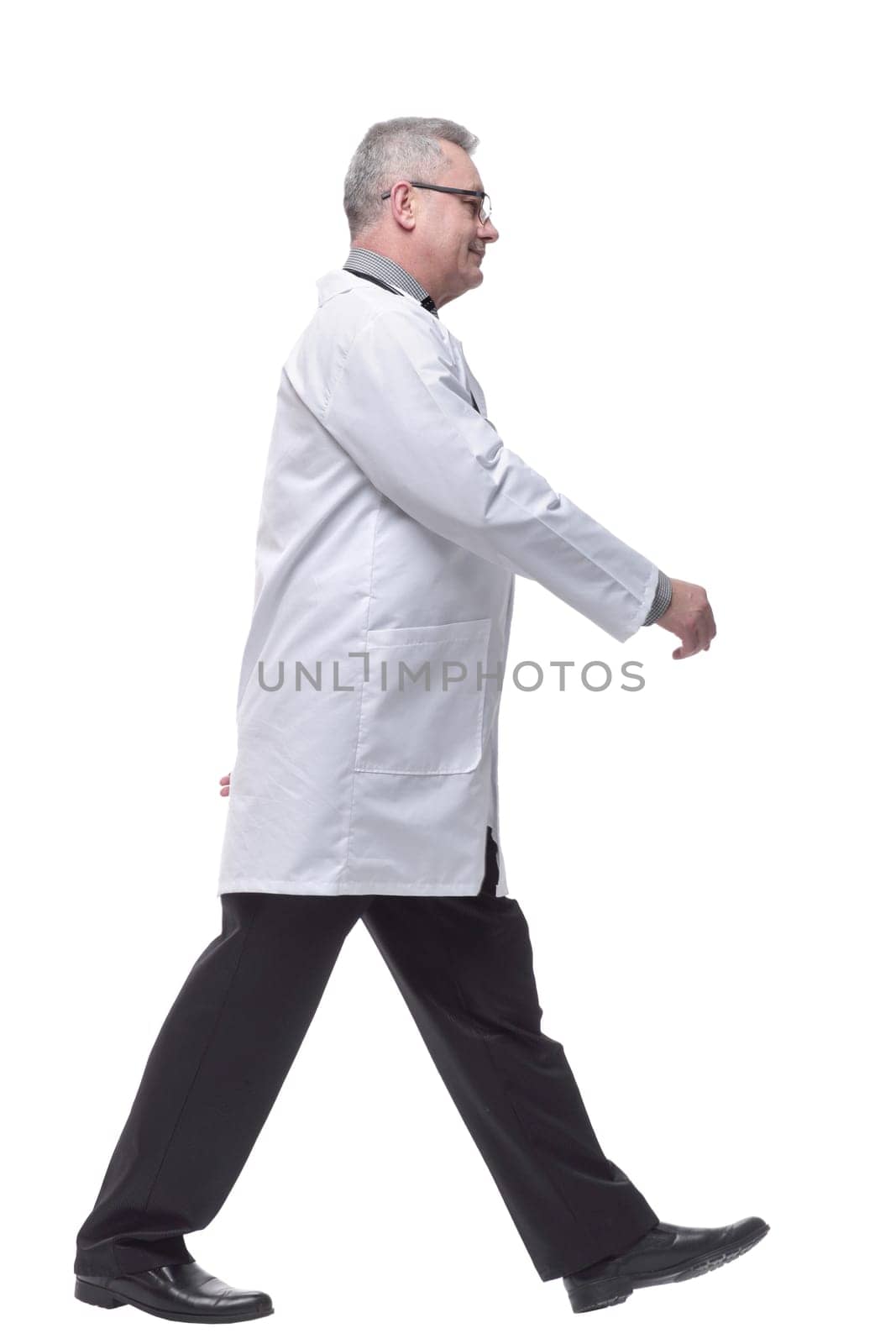 Walking mature doctor, side view. Full length studio shot by asdf