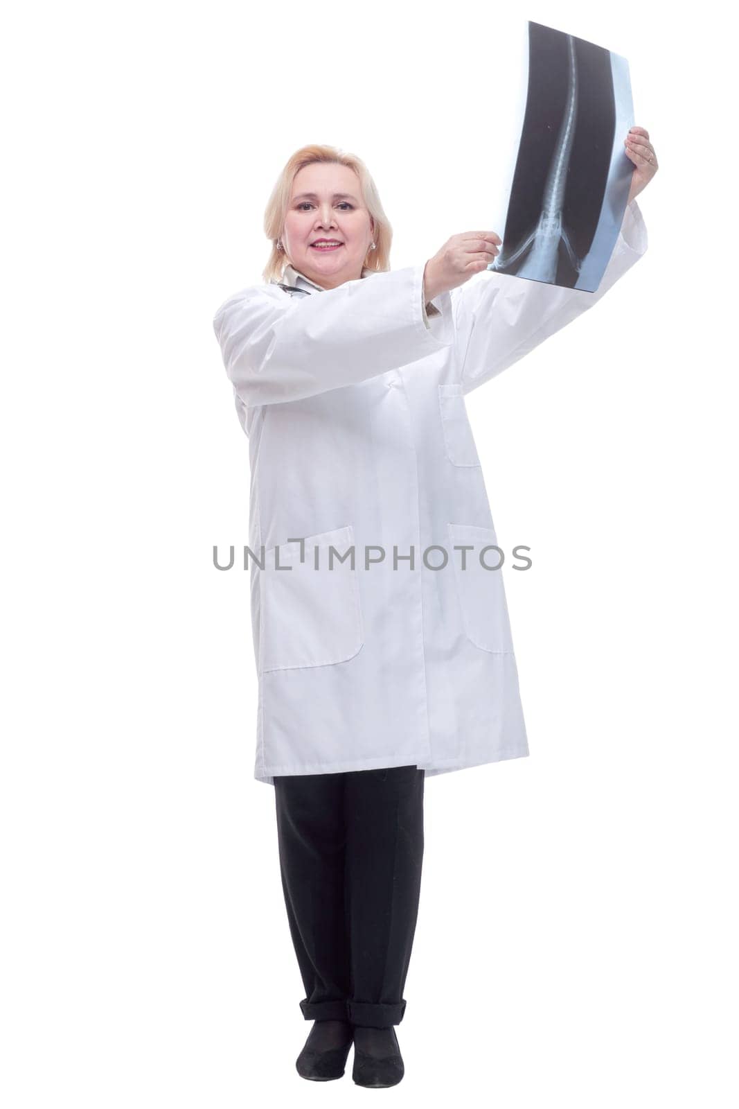 Nice doctor with stethoscope watching a patient x-ray