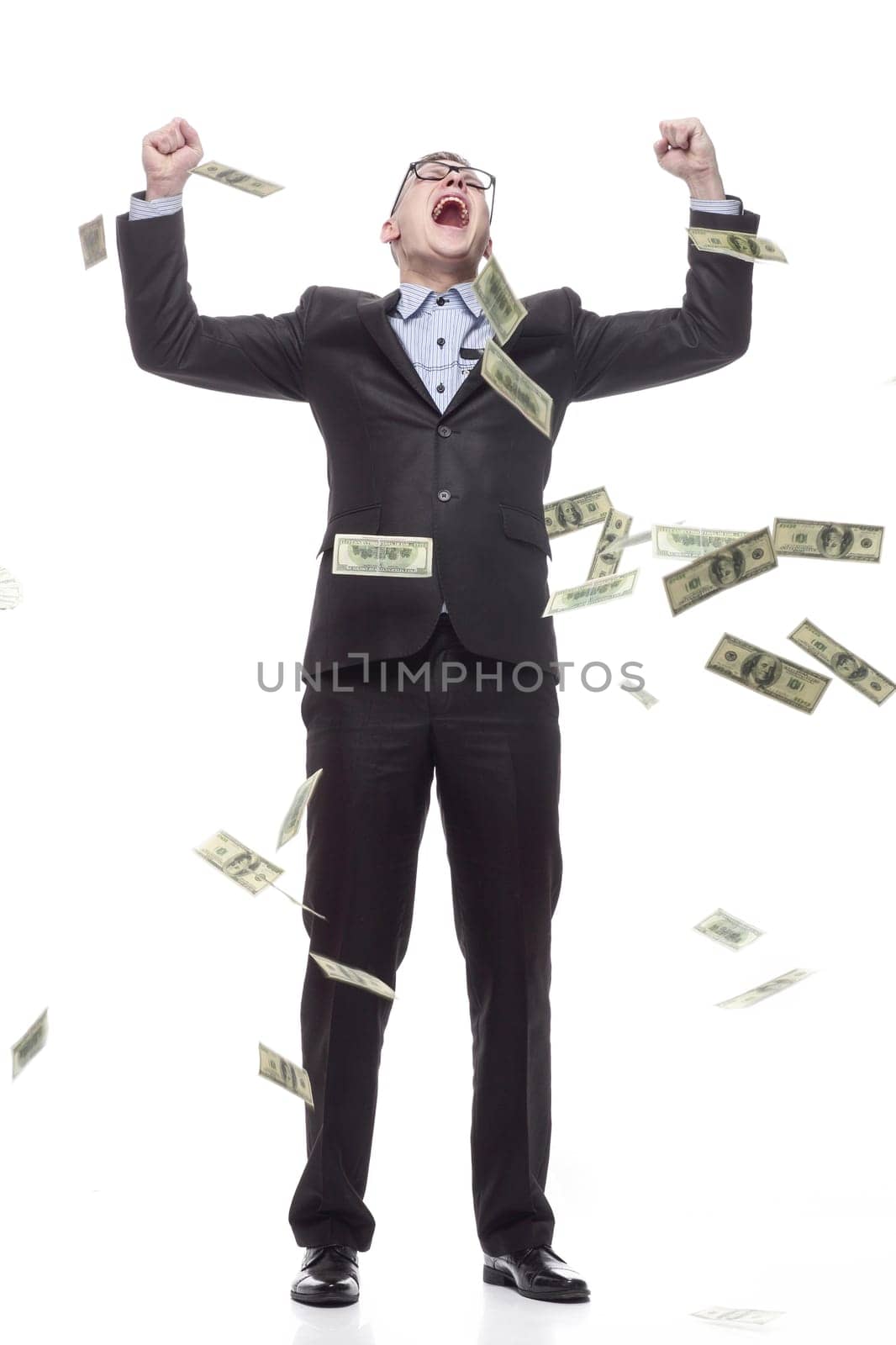 in full growth. happy young businessman with cash banknotes. isolated on a white background.