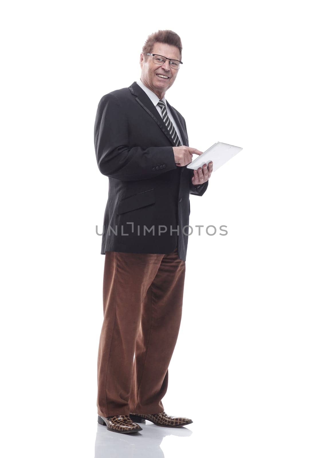 in full growth. happy business man with a digital tablet . isolated on a white background