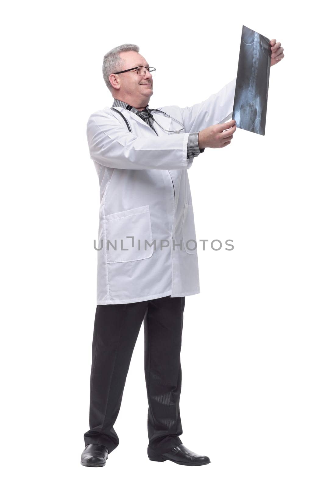 Attractive doctor examining an x-ray and smiling at the camera by asdf