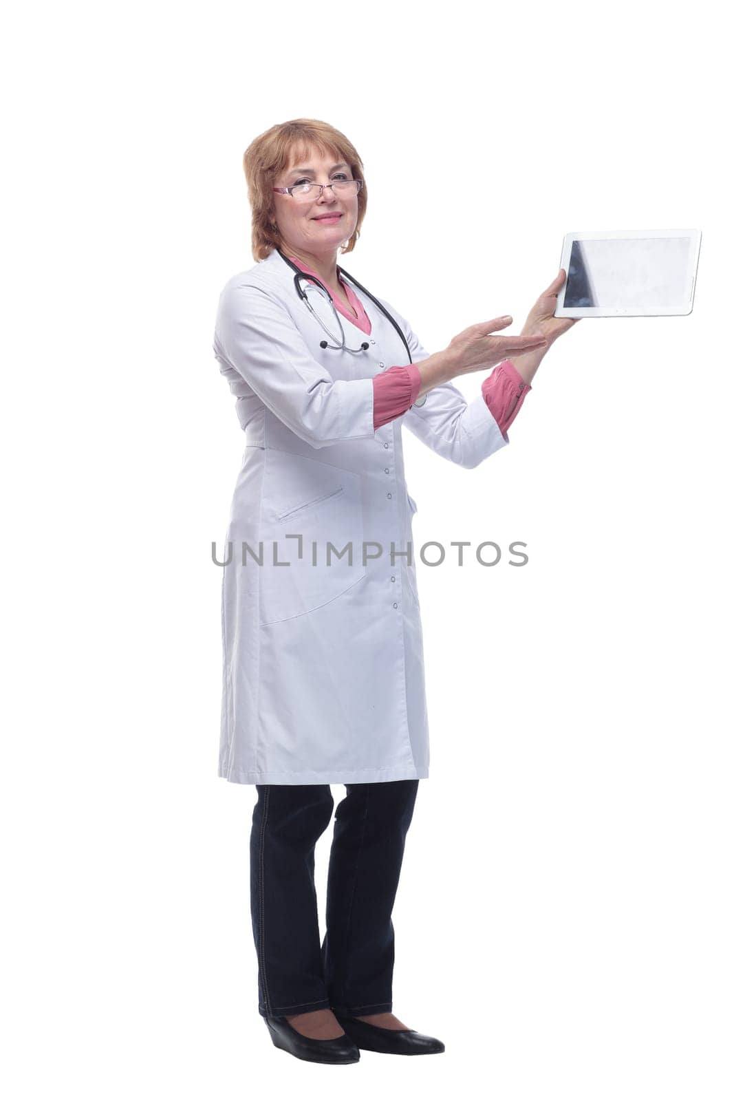 Happy doctor in lab coat and glasses using tablet pc on white background