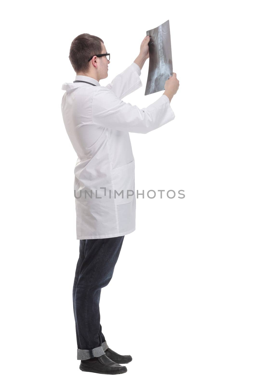 Front view of hospital doctor holding patient's x-ray film and lookind at it