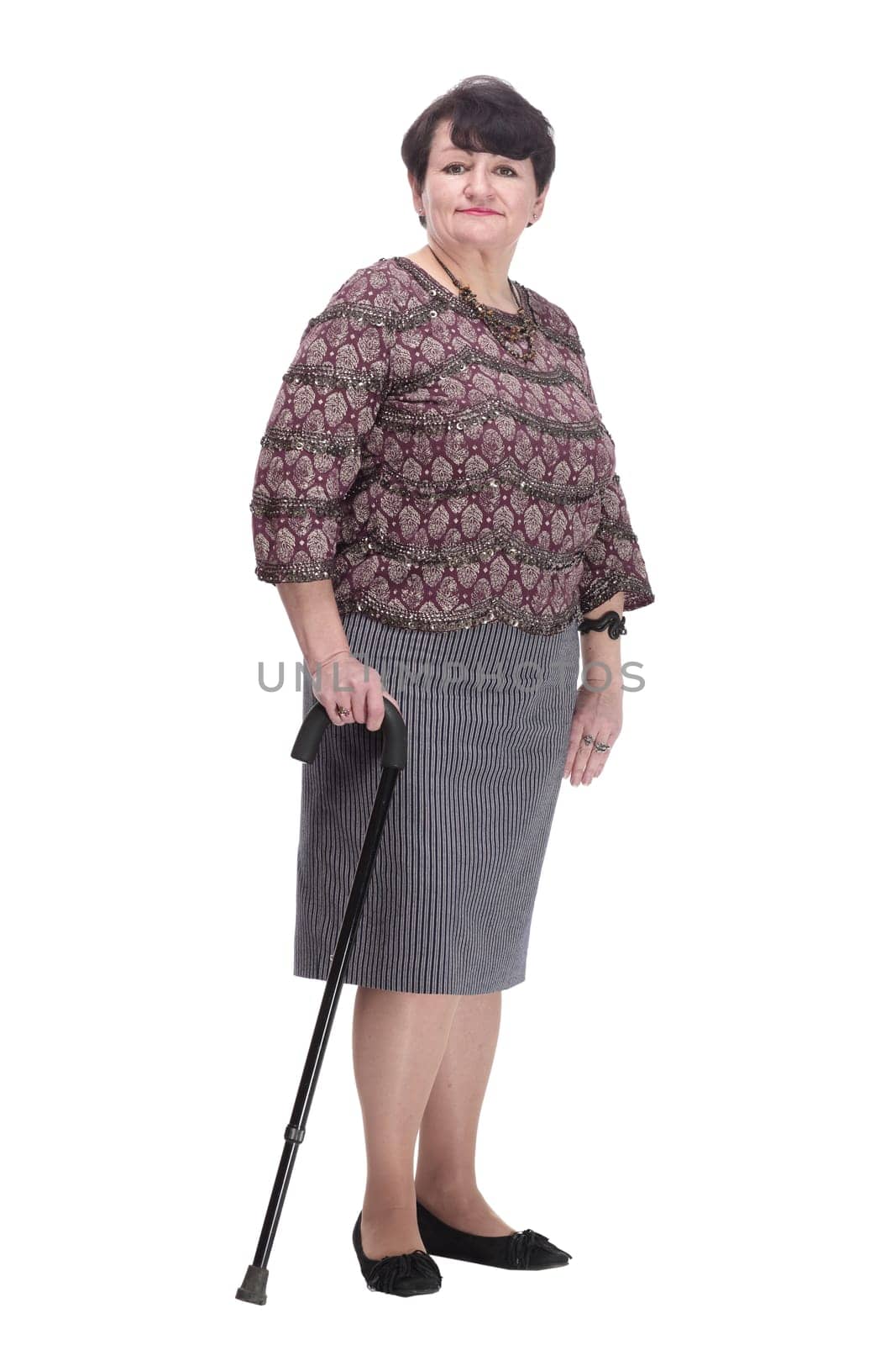 full-length. casual elderly woman with a walking stick. isolated on a white background.