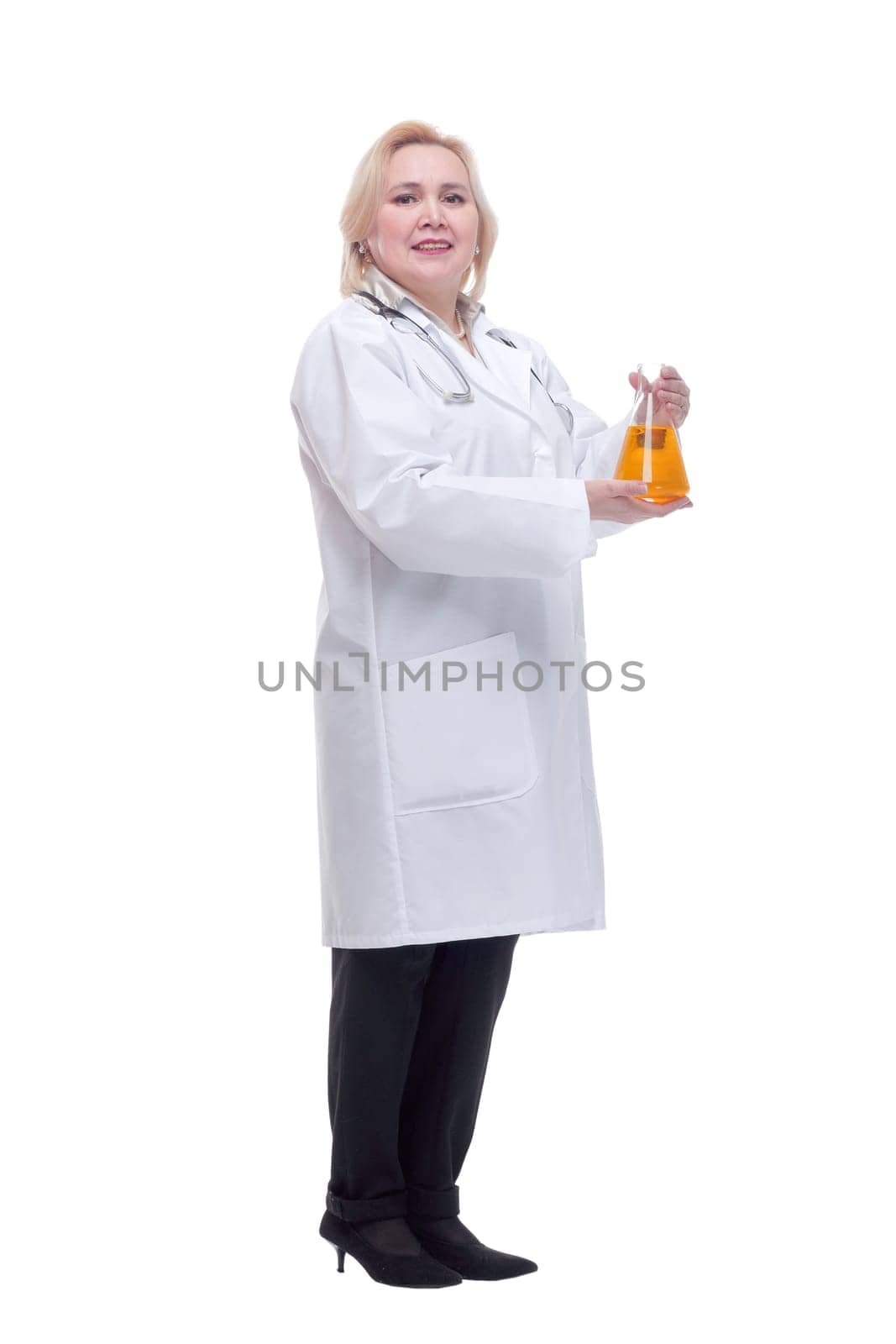 Front view of young female scientist working with liquids in laboratory